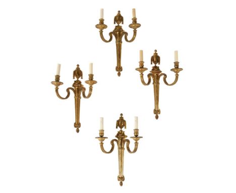 A SET OF FOUR LARGE ORMOLU TWIN LIGHT WALL APPLIQUES  FRENCH 19TH CENTURY, IN THE LOUIS XVI STYLE Each with scrolling candle 