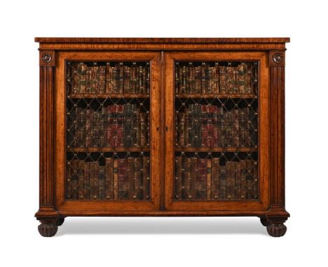 A REGENCY BROWN OAK LIBRARY CABINETATTRIBUTED TO GILLOWS OF LANCASTER, CIRCA 1820With brass trellis inset glazed doors enclos