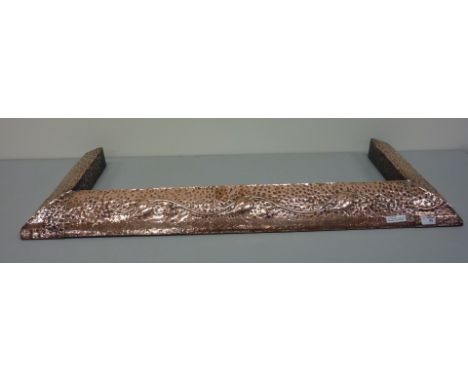 Arts and Crafts period embossed and beaten copper fender, W 98.5cm (121.5cm overall)  