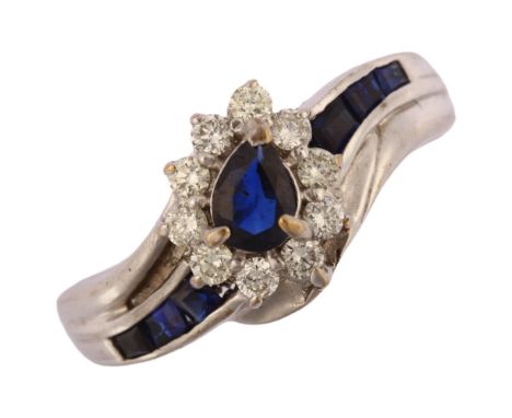 A modern 9ct white gold sapphire and diamond pear cluster crossover ring, total diamond content approx 0.2ct, setting height 