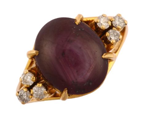 A late 20th century star ruby and diamond eye dress ring, unmarked gold settings with oval cabochon ruby and modern round bri