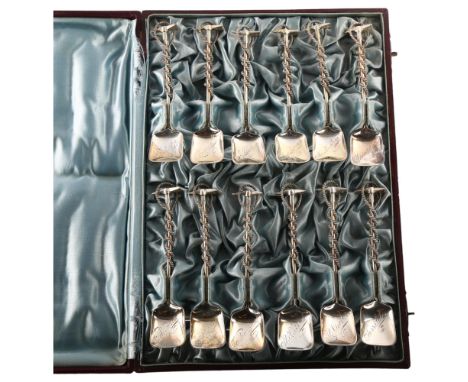 A set of 12 Continental silver mountaineering spoons, shovel form with ice axe and rope terminal, each bowl engraved with the