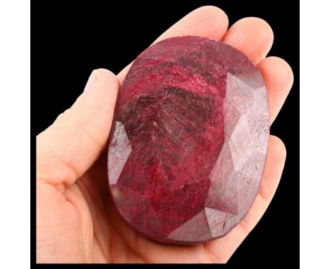 A 931.70ct unmounted oval mixed-cut ruby, 68.75 x 50.20 x 24.31mm, with IGL & I report cardNo damage, ruby has been colour en