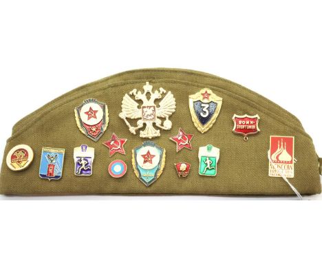 Russian Army cap decorated with fifteen enamel badges and three cloth badges. P&amp;P Group 1 (£14+VAT for the first lot and 