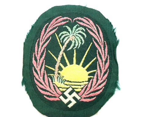 German WWII Afrika Korps embroidered fabric badge, the wreath hand coloured in pink to denote Armoured Division. P&amp;P Grou