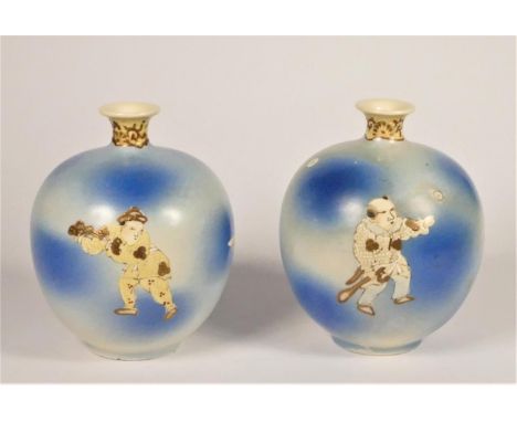 A 19th century pair of Japanese powder blue vases, unmarked, decorated with men playing a stick and ball game, 15cm 