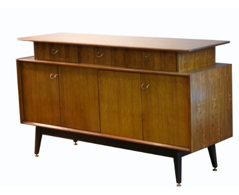 Victor Wilkins for E Gomme, G-Plan, a Librenza sideboard , c. 1960's, with a floating top with 3 drawers, middle drawer is a 