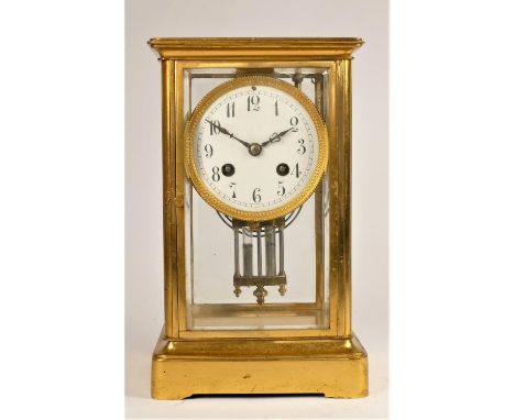 A French brass four glass mantle clock, the white enamel dial with Arabic numerals, the movement by F. Martie & Cie, numbered