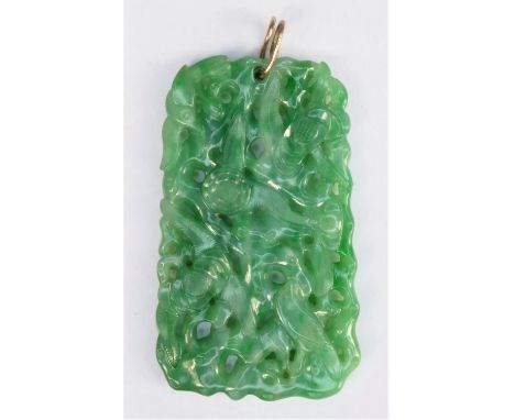 A Chinese green jade pendant, late Qing/Republic period, carved and pierced with birds amongst foliage, 52 x 31 x 4mmIn very 