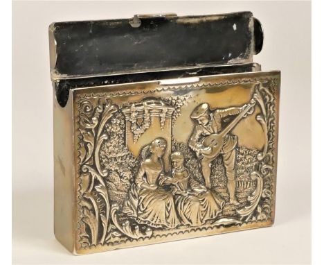 A Victorian silver playing card case, Marks worn, Birmingham 1899, the front embossed with a mandolin playing musician serena