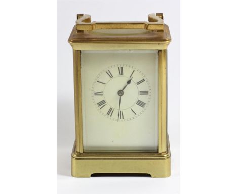 A brass 1/2 hour striking carriage clock, white enamel dial with Roman numerals, unsigned movement striking on a gong, lackin