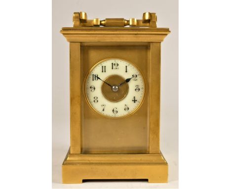 A French brass 1/2 hour striking carriage clock, the off white dial with Arabic numerals, the movement signed R & Co., Made i