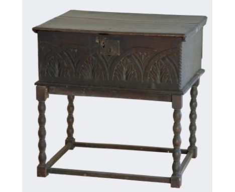 An 18th century and later oak bible box with carved front panel, raised on a later bobbin stand. 60 x 44 x 59cm. 