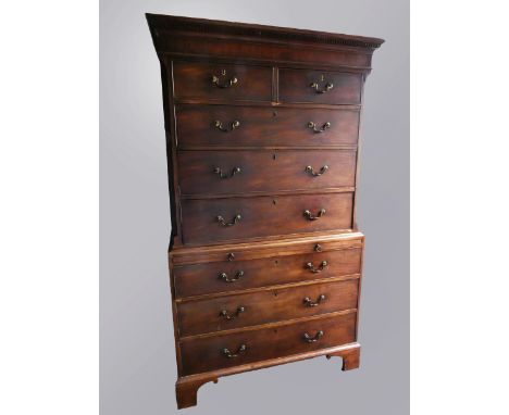 A George III mahogany chest-on-chest, with moulded dentil cornice, fitted with two short over six long drawers and brushing s
