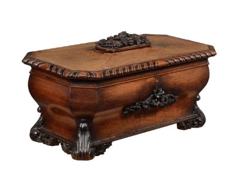 A VICTORIAN OAK SARCOPHAGUS SHAPED CELLARETMID 19TH CENTURYThe hinged top enclosing eight lead lined divisions59cm high, 108c