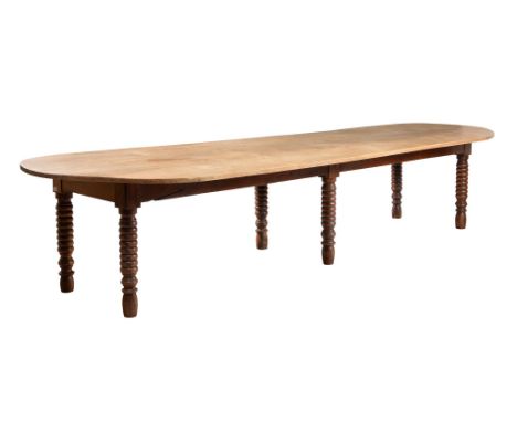 A LARGE BEECH AND WALNUT REFECTORY TYPE DINING TABLE INCORPORATING 19TH CENTURY AND LATER ELEMENTSThe oval top above bobbin t