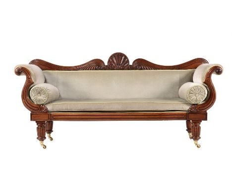 A WILLIAM IV MAHOGANY SOFA CIRCA 1830The crest centred with a shell flanked by stylised reeded scrolls and roundels, the reed