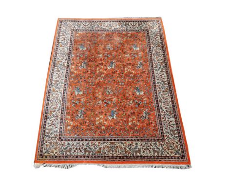 A HUNTING CARPET IN TABRIZ STYLEWith coral pink field woven with a design of closely formed equestrian figures, animals, bird