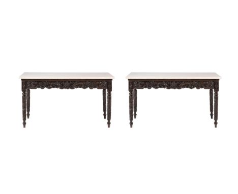 Y A PAIR OF ANGLO INDIAN EBONY CONSOLE TABLES WITH LATER MARBLE TOPSSECOND HALF 19TH CENTURY82cm high, 146cm wide, 74cm deepP