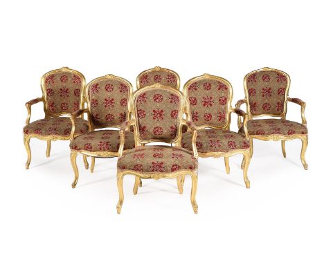 A SET OF SIX GEORGE III GILTWOOD AND TAPESTRY UPHOLSTERED ARMCHAIRSIN LOUIS XV STYLE, SECOND HALF 18TH CENTURYEach with shiel