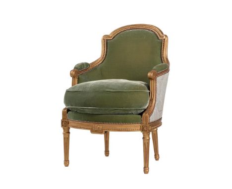 A FRENCH GILTWOOD AND UPHOLSTERED BERGÈRE ARMCHAIR, IN LOUIS XVI STYLE20TH CENTURY93cm high Condition Report: Marks, knocks, 