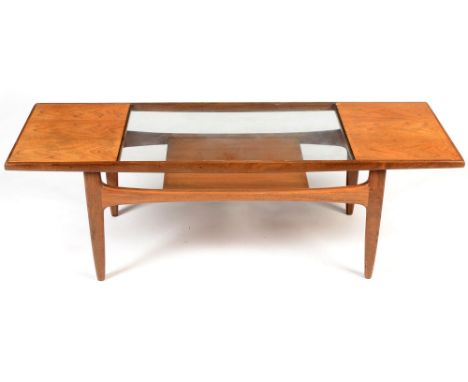 Victor Wilkins for G-Plan: a rectangular teak coffee table , bears label for c1970 to the underside, glass inset top and maga