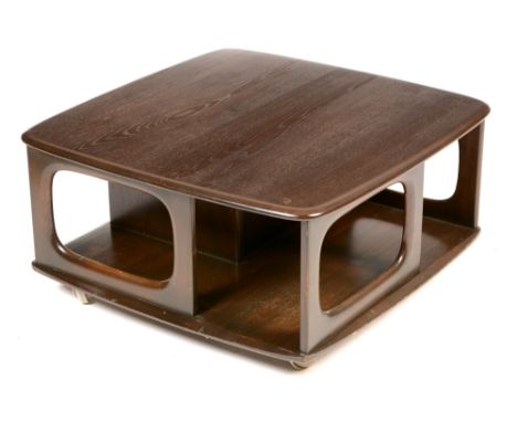 Ercol: a "Pandora" teak coffee table/revolving bookcase , with square top above an arrangement of pigeon holes and drawers, r