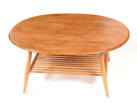 A mid Century Ercol Blonde coffee table , with oval top above tapering legs united by a slatted magazine rack below, 98.5 x 8