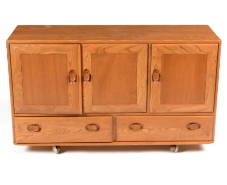 Ercol: an elm Windsor sideboard, No 429, with a two-door cupboard and adjustable shelf, another cupboard opening to reveal cu