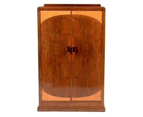 C.W.S Ltd: an Art Deco walnut cabinet , with caddy top above a pair of stained cupboard doors enclosing and interior, raised 