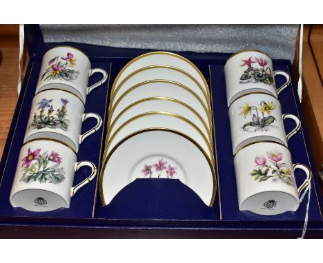 A BOXED ROYAL WORCESTER SET OF SIX COFFEE CANS AND SAUCERS PRINTED WITH BOTANICAL STUDIES, gilt rims, appear to be in unused/