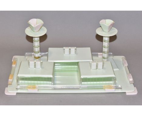 AN ART DECO PINK, GREEN AND CLEAR PLASTIC DRESSING TABLE SET, comprising rectangular tray, a pair of candlesticks and three r