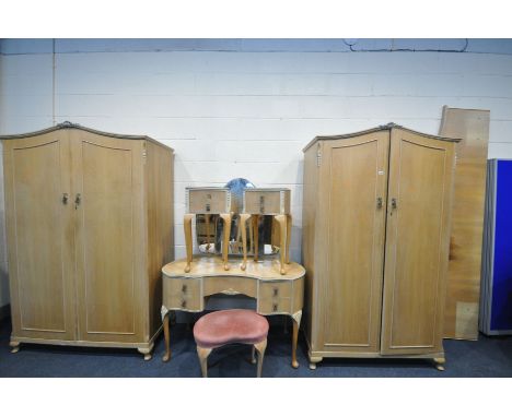 A FRENCH LIGHT WALNUT BEDROOM SUITE, labelled 'Walnut cabinet works', comprising of two sized double door wardrobes, largest 