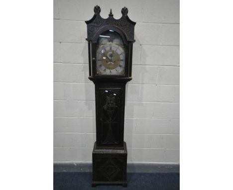 A GEORGIAN CARVED OAK LONGCASE CLOCK, the hood enclosing a brass 10 1/2' dial, moonphase to arch, eight day movement, foliate