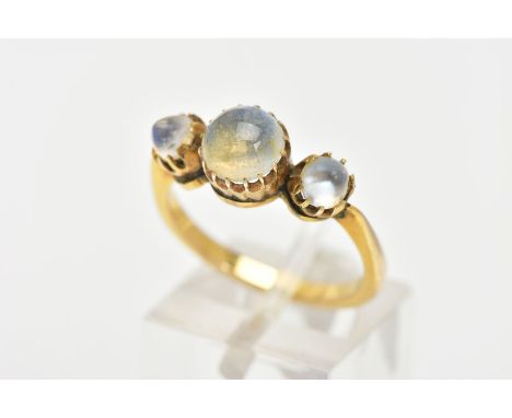 A YELLOW METAL MOONSTONE RING, designed with a central circular cut moonstone and flanked with two domed moonstones, tapered 