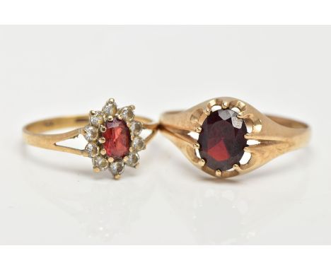 TWO 9CT GOLD GARNET RINGS, the first of an oval design set with an oval cut garnet within a ten claw setting, leading on to a