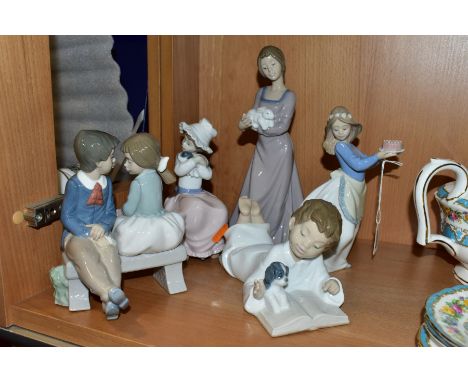 FIVE NAO PORCELAIN FIGURES OF CHILDREN, four of them modelled with their pets, the fifth modelled as a boy and girl on a benc