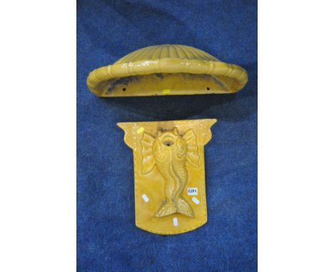 A GLAZED TERRACOTTA WATER FEATURE/FOUNTAIN, in two parts, with wall mounted cartouche depicting a mythical creature, above a 