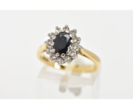 A SAPPHIRE AND DIAMOND CLUSTER RING, a blue oval sapphire prong set with twelve round brilliant cut diamonds, white gold pron