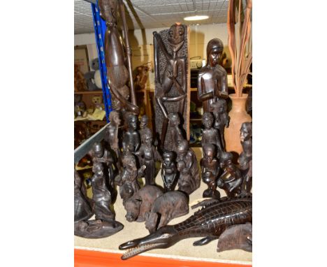 A GROUP OF CARVED HARDWOOD AFRICAN FIGURES, to include a nativity set from Dar-es-Salaam, Tanzania, once displayed in Lichfie