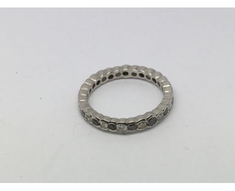 A white gold ring, possibly 9ct, set with alternating white and blue diamonds, approx 2.4g and approx size M-N.