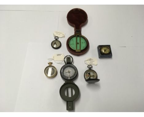A collection of 6 military compasses to include a Barker 1906 glow needle and Barker Mod 88 compass