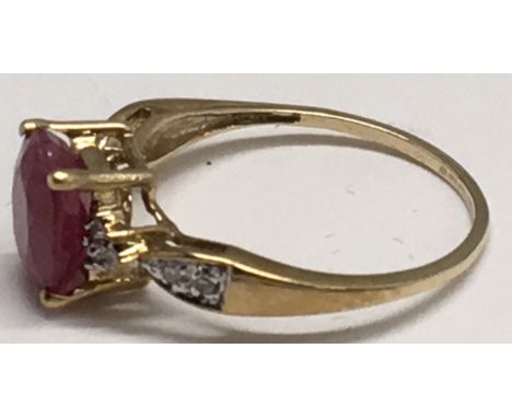 A 9ct gold ring set with a ruby type stone.Approx size N