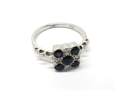 A 9carat White gold ring set with blue sapphire and small diamonds.Ring Size P.