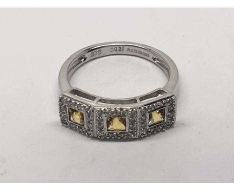 A 9 carat gold ring set with Topaz and diamonds Ring Size M.