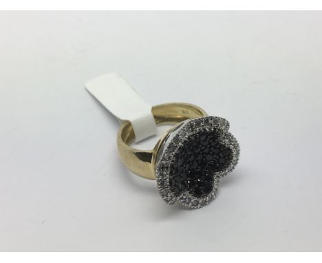 A heavy 9ct gold black and white stone set cluster ring, approx 6.3g and approx size M-N.