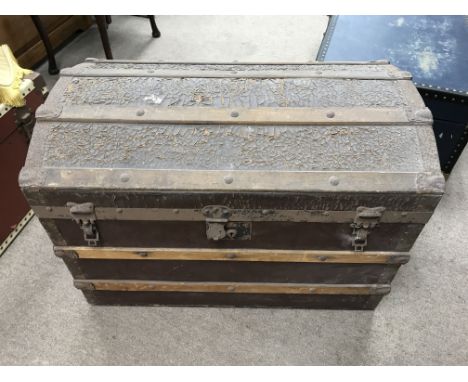 A domed trunk with various contents together with an additional travelling trunk.