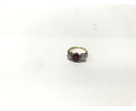 An 18ct yellow gold ring set with a central ruby flanked by two diamonds. Weight approx 3.6g, size approx K