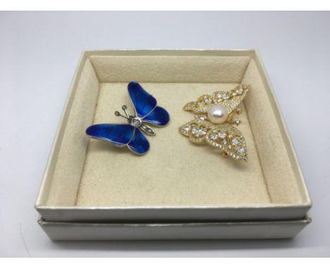 Two butterfly brooches, one set with enamel and seed pearls, the other set with a central cultured pearl surrounded by diamon