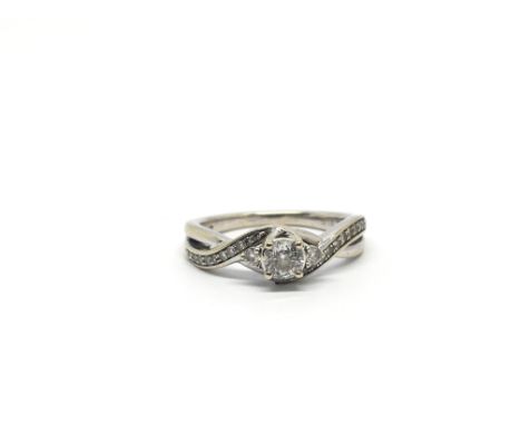 An 18ct white gold engagement ring inset with diamonds. In original retail box, with receipt.